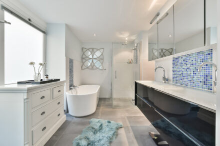 Luxurious bathroom renovation with freestanding tub, mosaic tiles, and walk-in shower in Guelph by Varoco Inc.