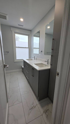 Modern bathroom renovation in Waterloo Region featuring a custom double vanity, premium tile flooring, and contemporary finishes.