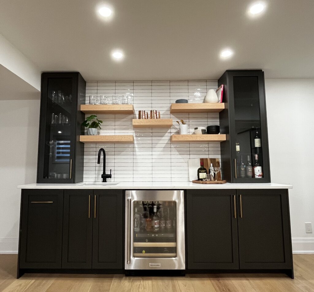 Sleek black kitchen renovation with custom cabinets and modern finishes in Kitchener Waterloo Ontario.