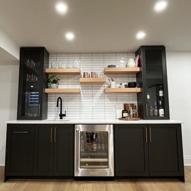 Sleek black kitchen renovation with custom cabinets and modern finishes in Kitchener Waterloo Ontario.
