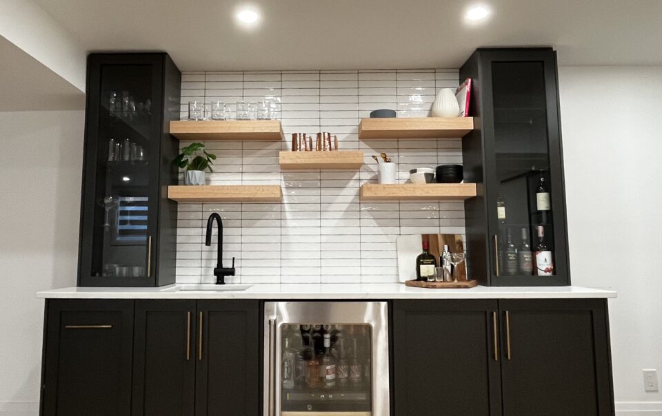 Sleek black kitchen renovation with custom cabinets and modern finishes in Kitchener Waterloo Ontario.